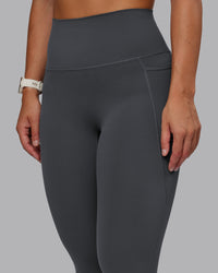 Woman wearing Elixir Ultra High-Rise 7/8 Legging Pockets - Dark Storm | Model:Lyss | Size:S