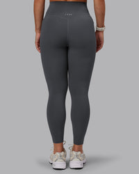 Woman wearing Elixir Ultra High-Rise 7/8 Legging Pockets - Dark Storm | Model:Lyss | Size:S