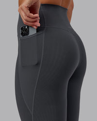 Woman wearing Elixir Ultra High-Rise 7/8 Legging Pockets - Dark Storm | Model:Lyss | Size:S