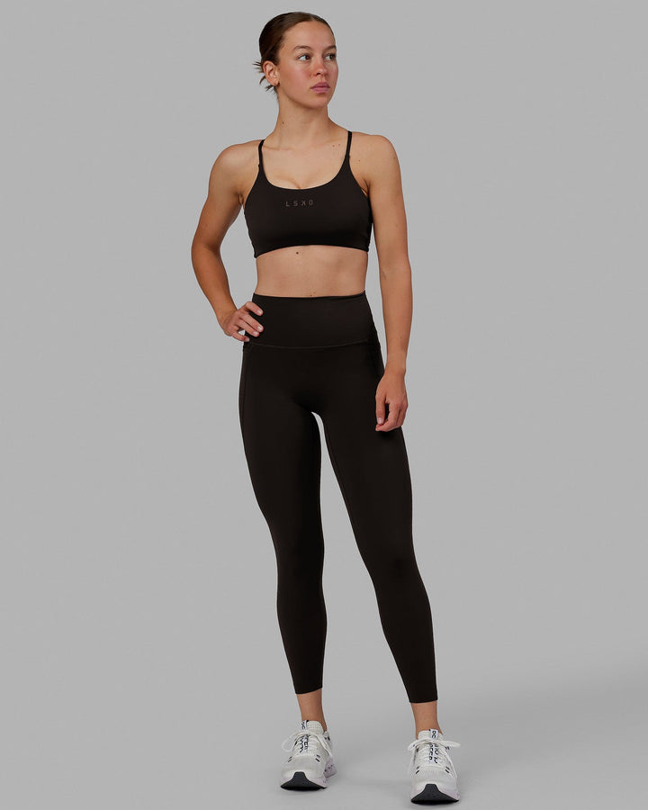 Woman wearing Elixir 7/8 Length Tights With Pockets - Dark Walnut