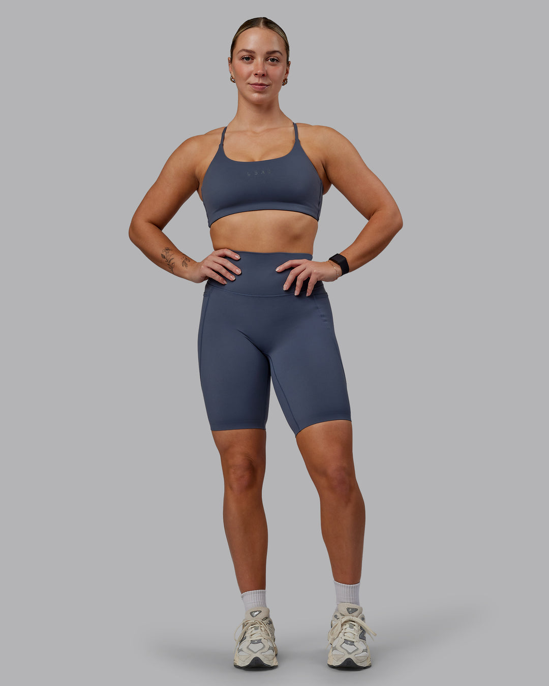 Woman wearing Elixir Ultra High-Rise 9&quot; Short Pockets - Turbulence | Model:Suz | Size:S