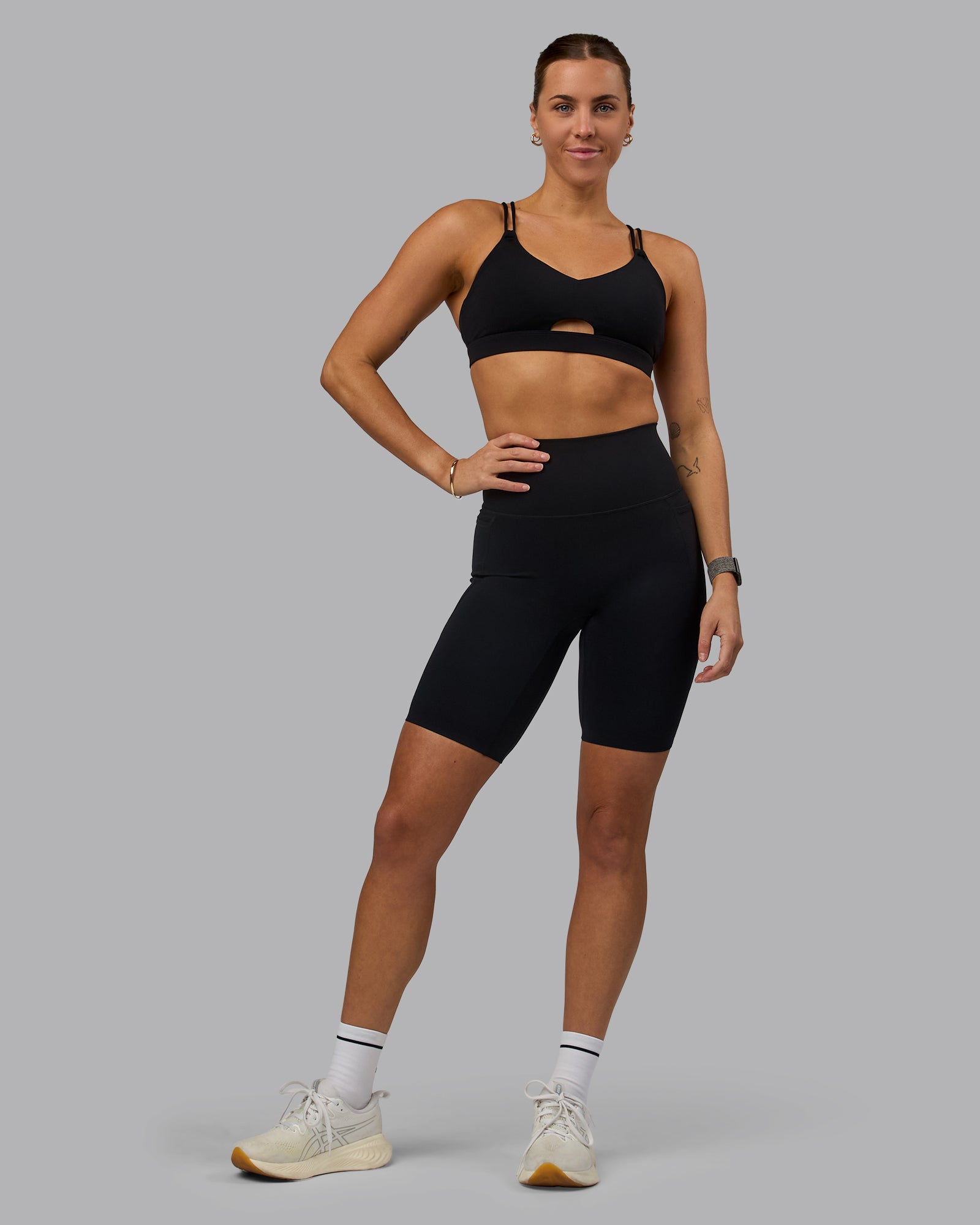 Woman wearing Elixir Ultra High-Rise 9" Short Pockets - Black | Model:Shae | Size:S
