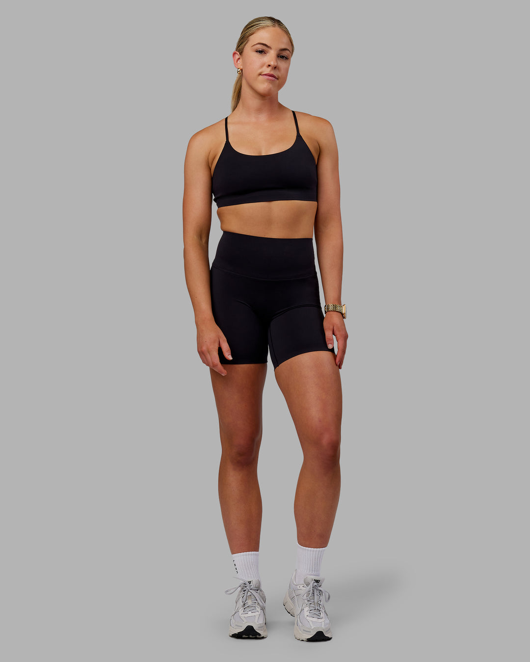 Woman wearing Elixir Ultra High-Rise Bonded Waistband 6" Short - Black | Model:Caitlin | Size:S