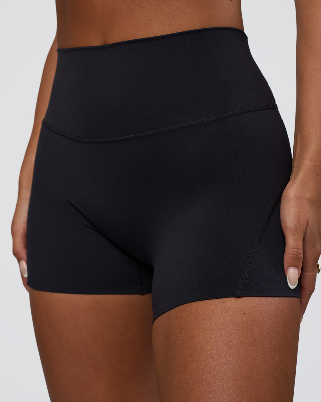 Woman wearing Elixir Defined High-Rise 4&quot; Short Pockets - Black | Model:Bianca | Size:S