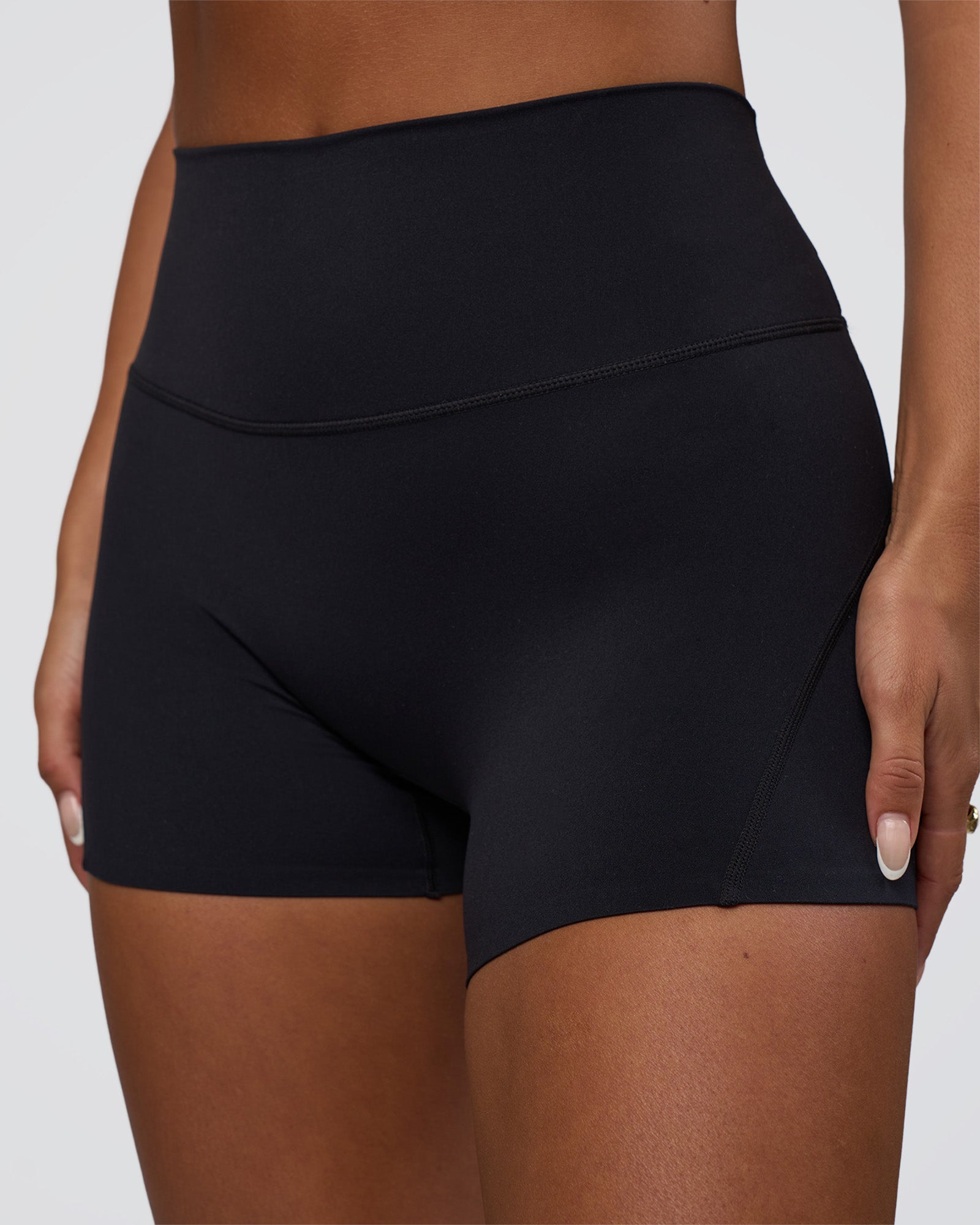 Woman wearing Elixir Defined High-Rise 4" Short Pockets - Black | Model:Bianca | Size:S