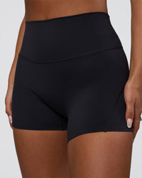 Woman wearing Elixir Defined High-Rise 4" Short Pockets - Black | Model:Bianca | Size:S