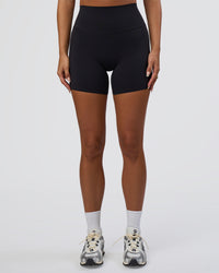 Woman wearing Elixir Defined High-Rise 6" Short Pockets - Black | Model:Bianca | Size:S