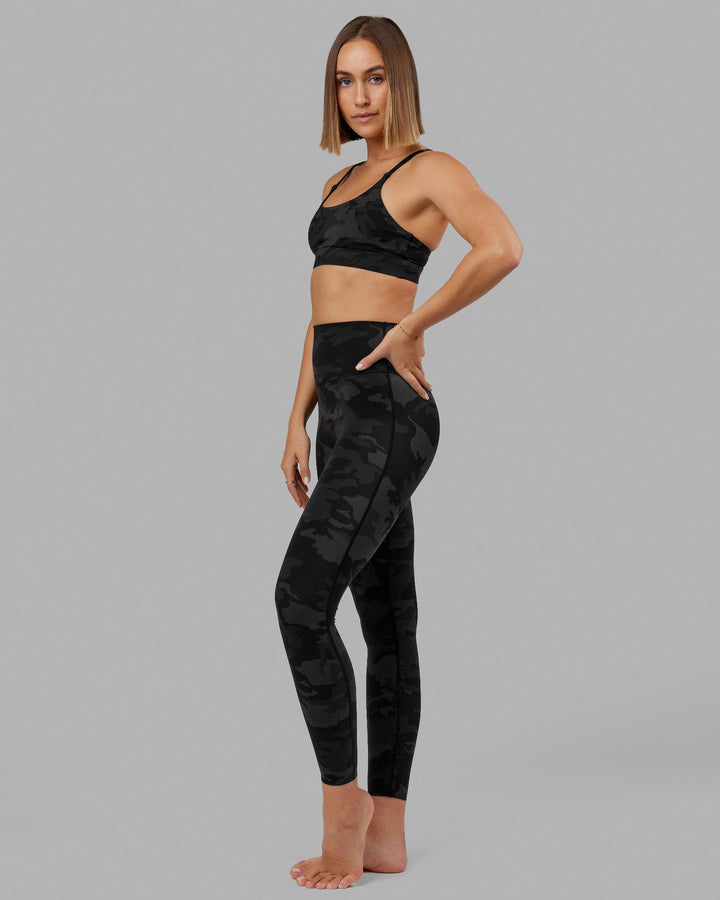 Woman wearing Elixir Full Length Tight - Black Camo
