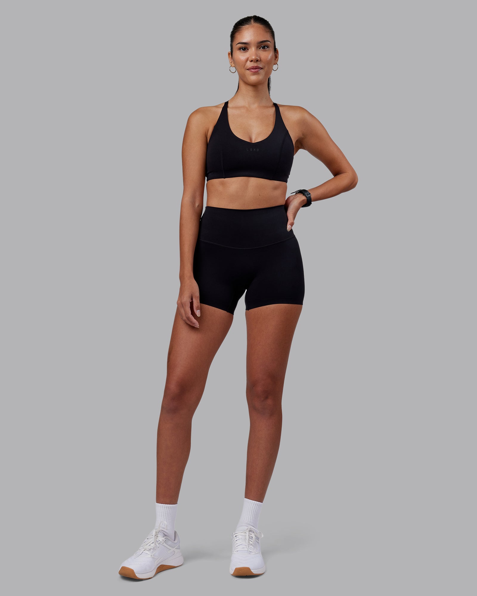 Woman wearing Elixir High-Rise 4" Short - Black | Model:Rhiley | Size:S