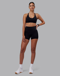 Woman wearing Elixir High-Rise 4" Short - Black | Model:Rhiley | Size:S