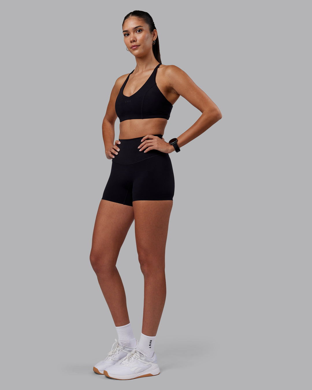 Woman wearing Elixir High-Rise 4&quot; Short - Black | Model:Rhiley | Size:S