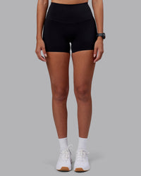 Woman wearing Elixir High-Rise 4" Short - Black | Model:Rhiley | Size:S