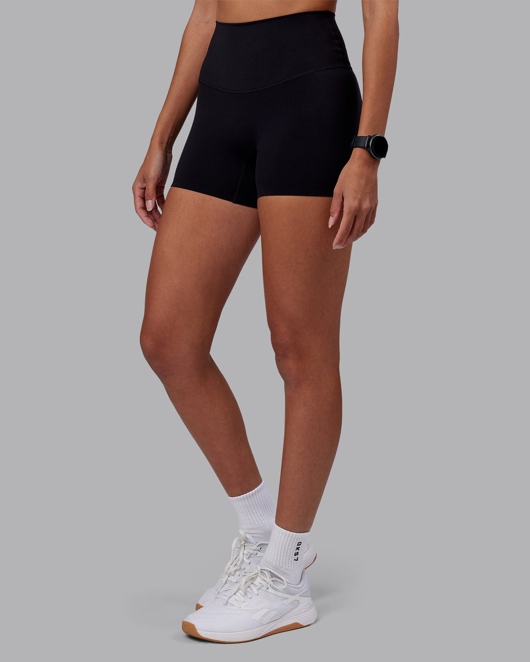 Woman wearing Elixir High-Rise 4&quot; Short - Black | Model:Rhiley | Size:S