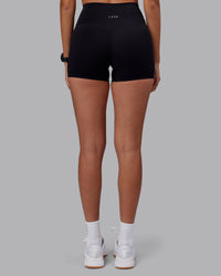 Woman wearing Elixir High-Rise 4" Short - Black | Model:Rhiley | Size:S