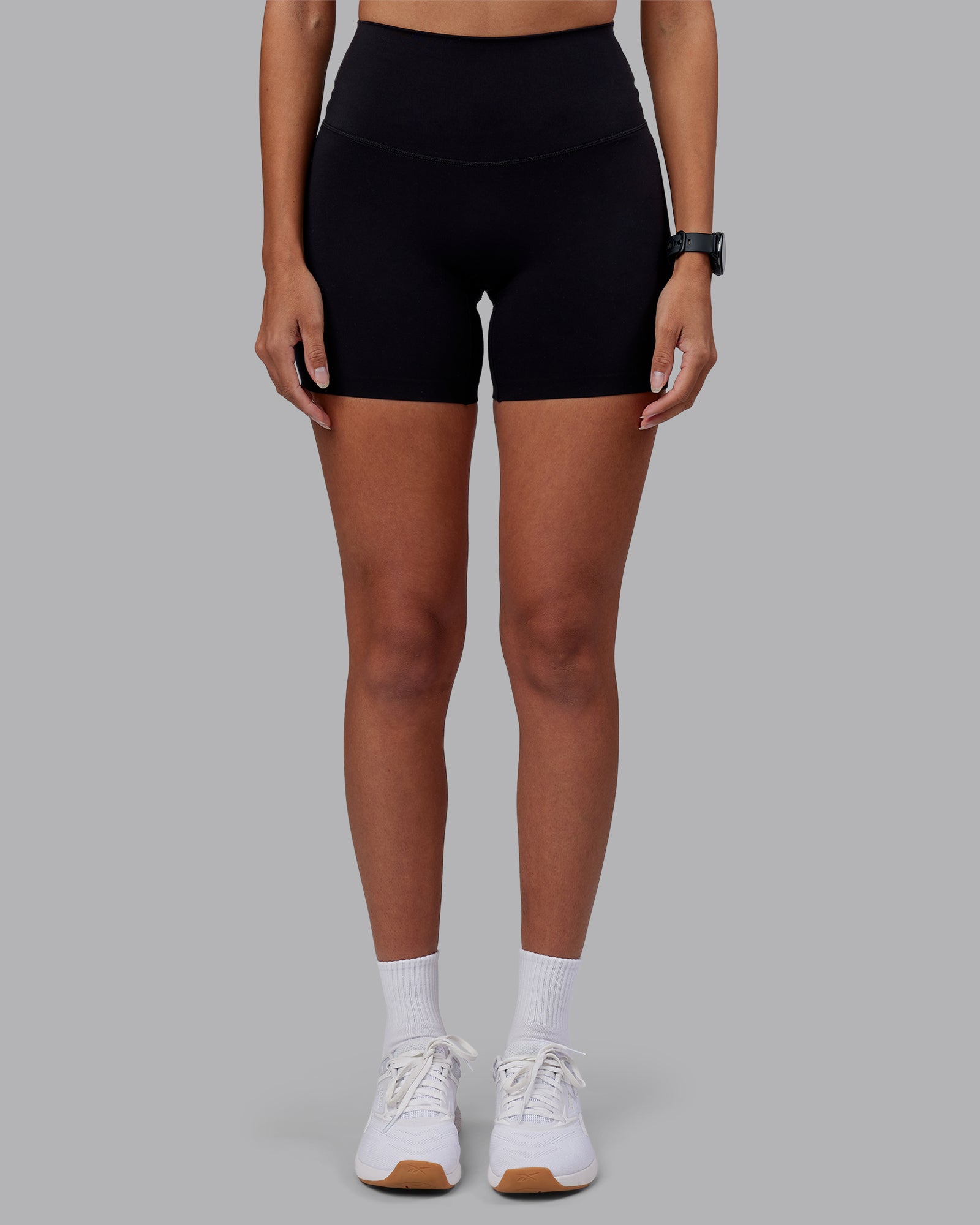 Woman wearing Elixir High-Rise 6" Short - Black | Model:Rhiley | Size:S