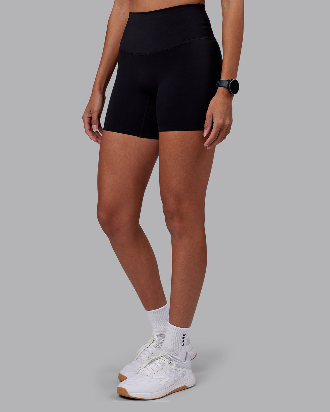 Woman wearing Elixir High-Rise 6&quot; Short - Black | Model:Rhiley | Size:S