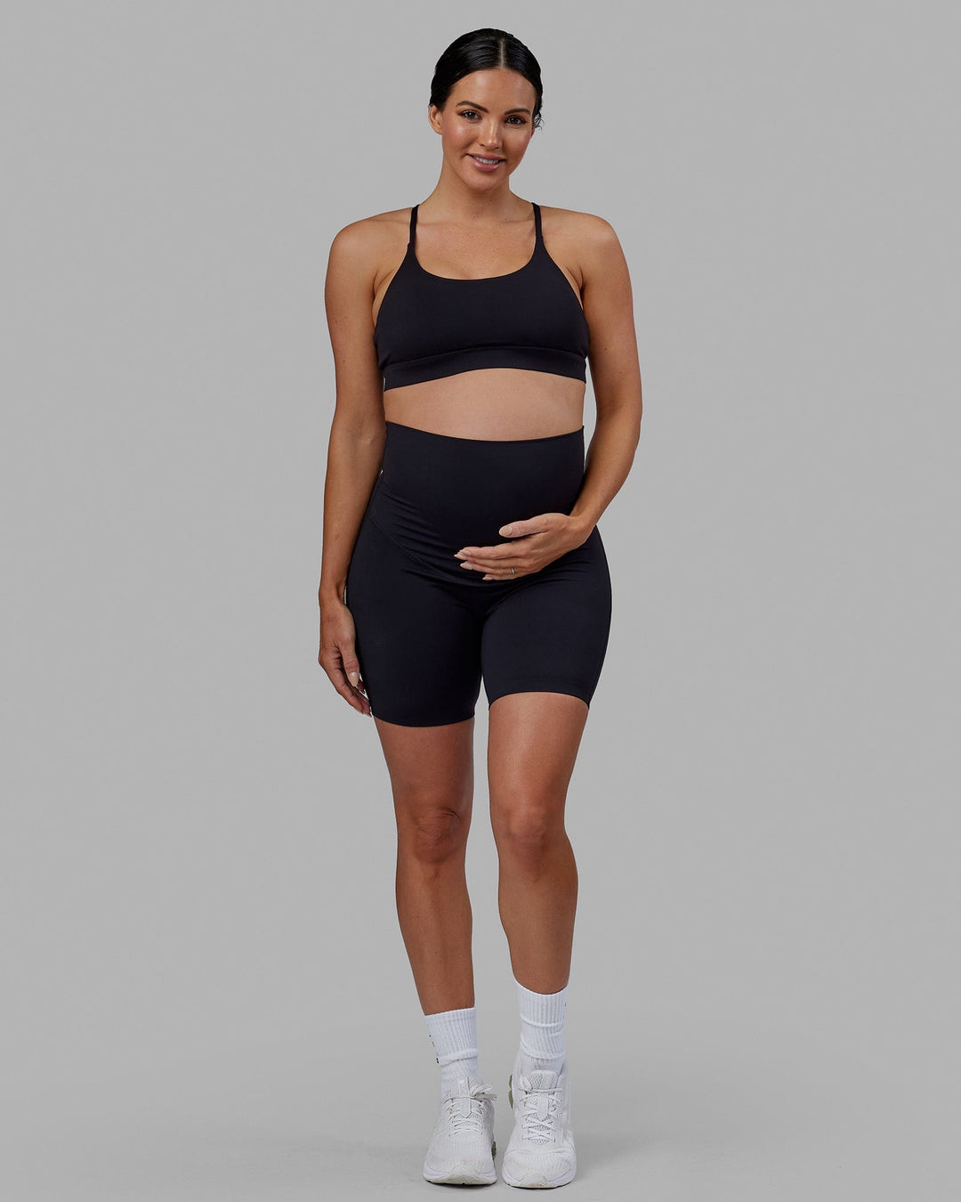Woman wearing Elixir Ultra High-Rise Maternity 6&quot; Short - Black | Model:Amanda | Size:S