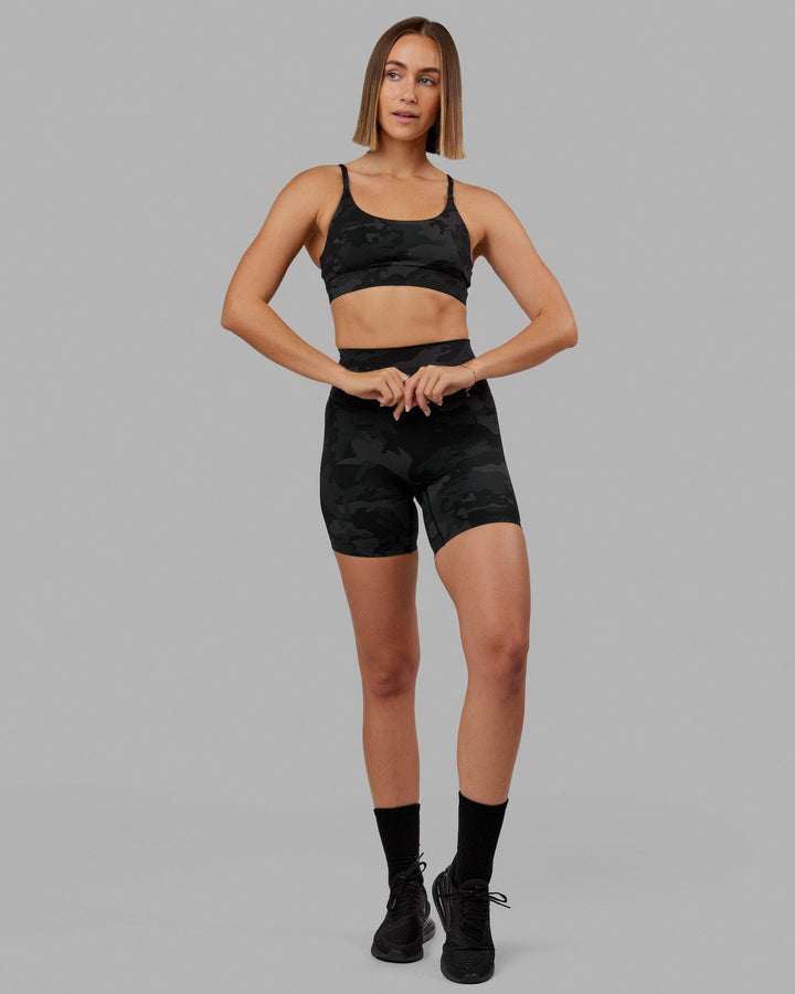 Woman wearing Elixir Mid Short Tight - Black Camo