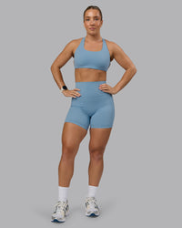 Woman wearing Elixir Ultra High-Rise 6" Short Pockets - Glacier Lake