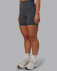 Woman wearing Elixir Ultra High-Rise 6" Short Pockets - Dark Storm | Size:S