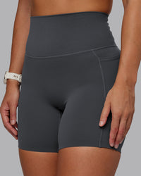 Woman wearing Elixir Ultra High-Rise 6" Short Pockets - Dark Storm | Size:S