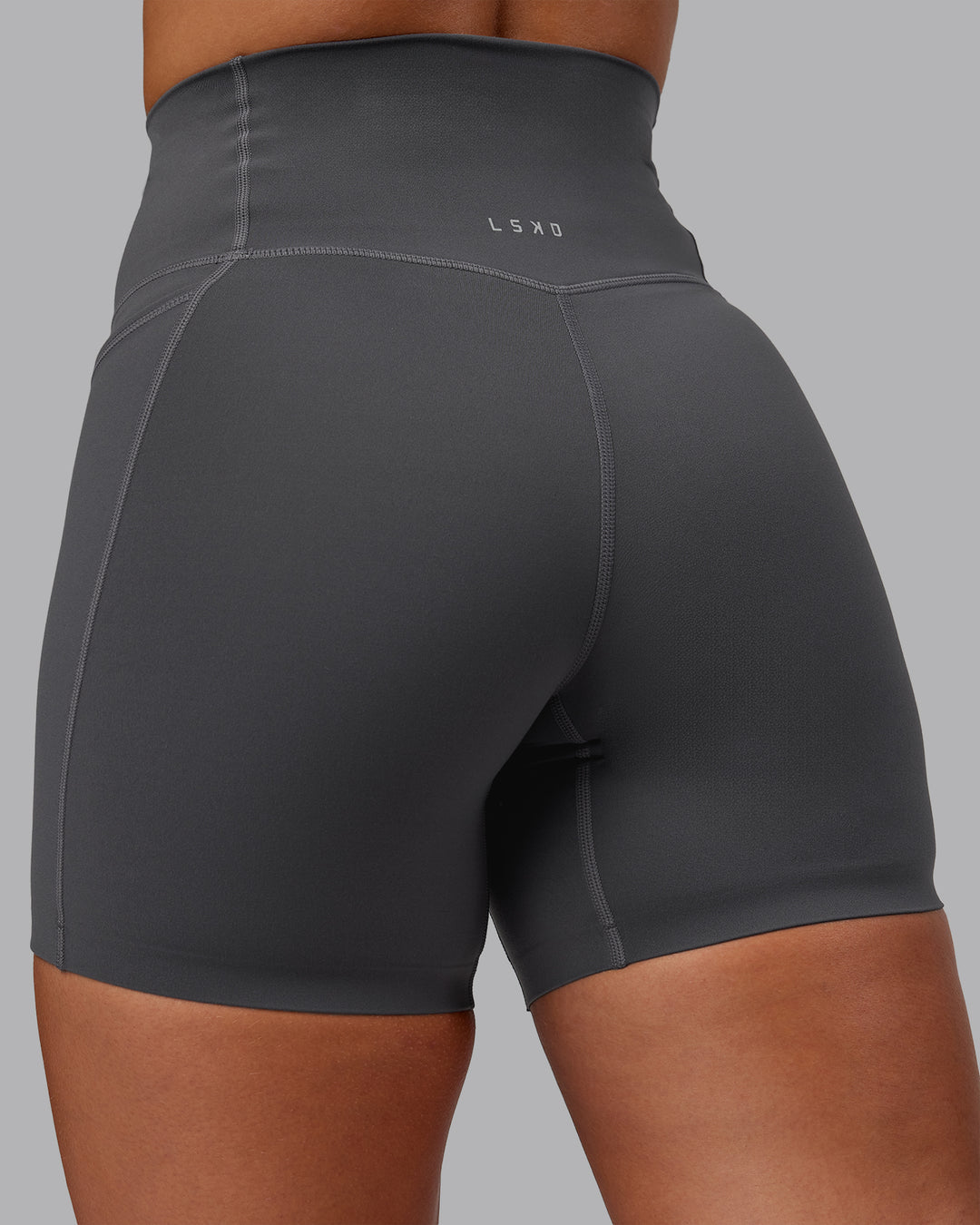 Woman wearing Elixir Ultra High-Rise 6" Short Pockets - Dark Storm | Size:S