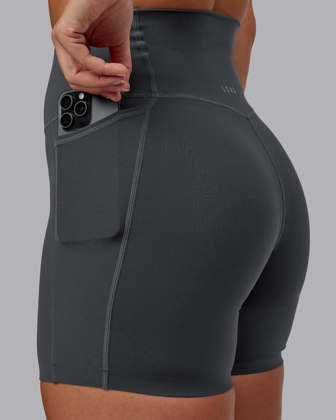 Woman wearing Elixir Ultra High-Rise 6" Short Pockets - Dark Storm | Size:S