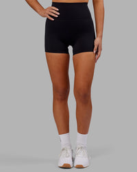 Woman wearing Elixir Ultra High-Rise 4" Short - Black | Model:Kirstyn | Size:S