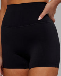 Woman wearing Elixir Ultra High-Rise 4" Short - Black | Model:Kirstyn | Size:S