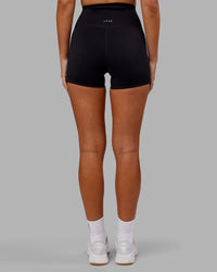 Woman wearing Elixir Ultra High-Rise 4" Short - Black | Model:Kirstyn | Size:S