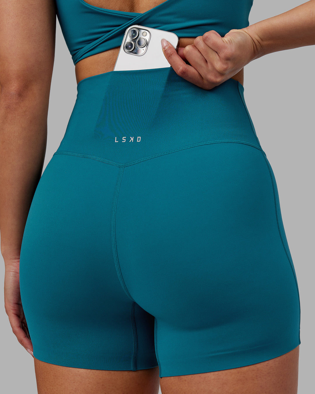 Woman wearing Elixir Ultra High-Rise 4&quot; Short - Blue Coral | Model:Ayla | Size:S