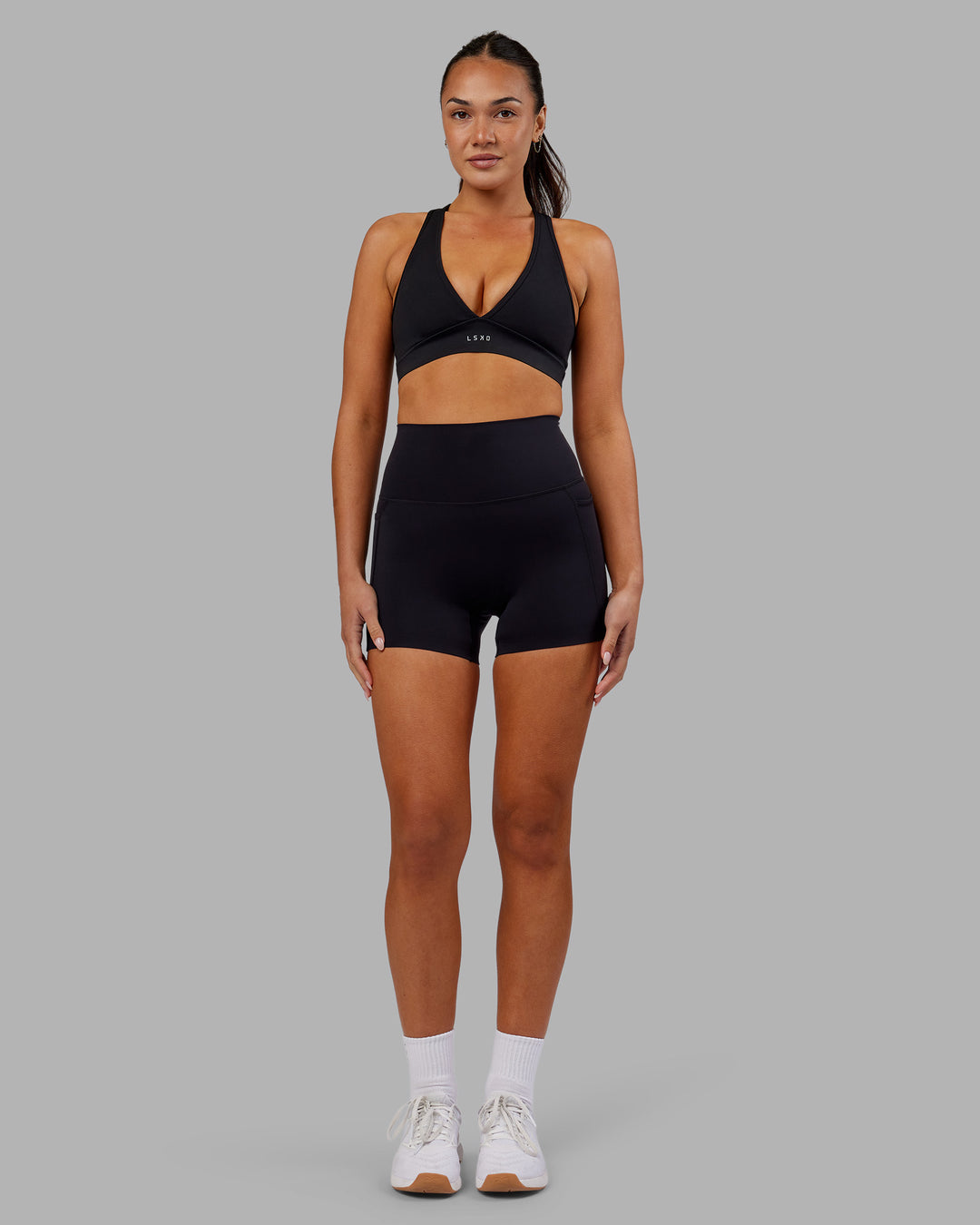 Woman wearing Elixir Ultra High-Rise 4&quot; Short Pockets - Black | Model:Kirstyn | Size:S