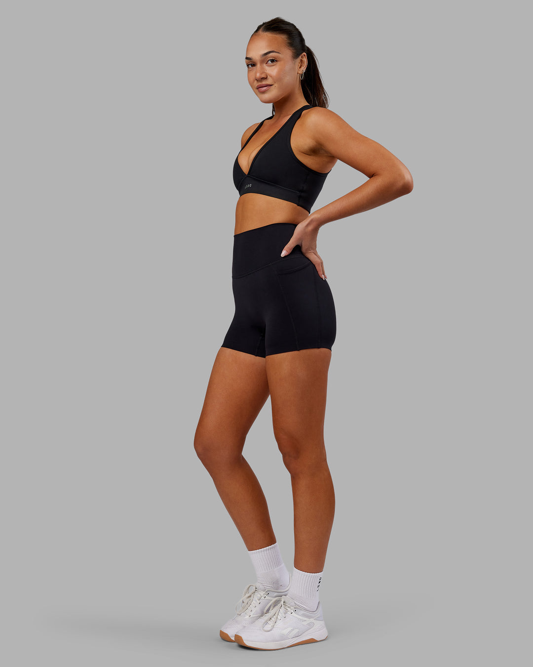 Woman wearing Elixir Ultra High-Rise 4&quot; Short Pockets - Black | Model:Kirstyn | Size:S