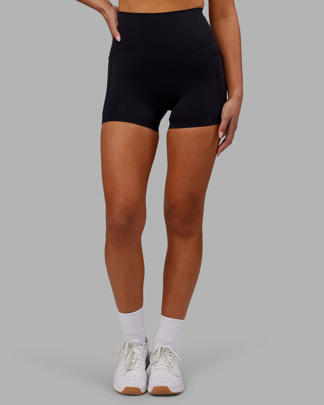 Woman wearing Elixir Ultra High-Rise 4&quot; Short Pockets - Black | Model:Kirstyn | Size:S