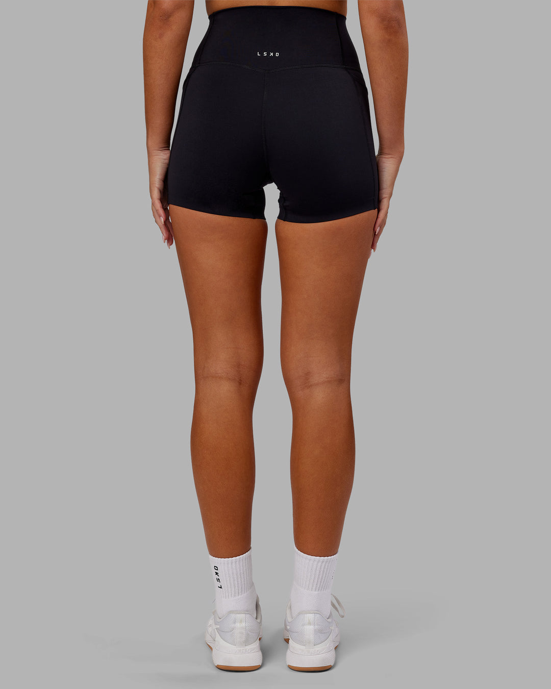 Woman wearing Elixir Ultra High-Rise 4&quot; Short Pockets - Black | Model:Kirstyn | Size:S