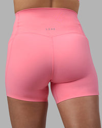 Woman wearing Elixir Ultra High-Rise 4" Short Pockets - Candy Pink | Model:Phoebe | Size:S