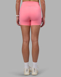 Woman wearing Elixir Ultra High-Rise 4" Short Pockets - Candy Pink | Model:Phoebe | Size:S