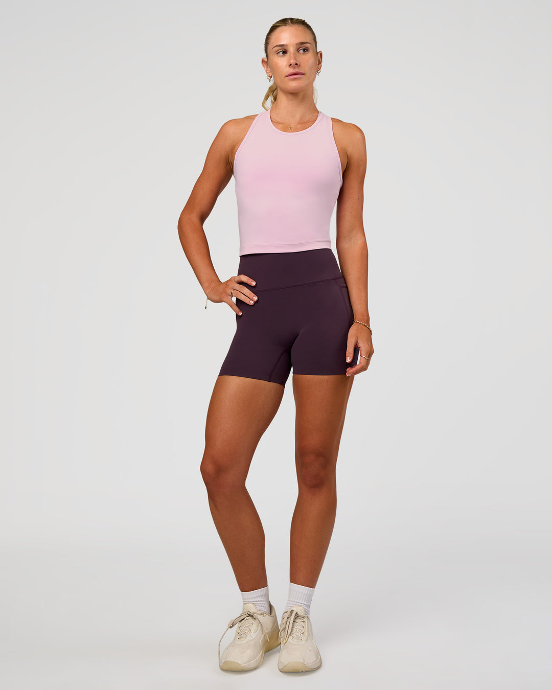 Woman wearing Elixir Ultra High-Rise 4" Short Pockets - Midnight Plum | Model:Emelia | Size:S