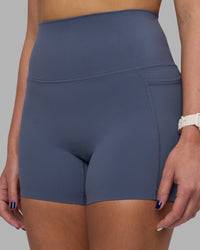 Woman wearing Elixir Ultra High-Rise 4" Short Pockets - Night Shadow | Model:Phoebe | Size:S
