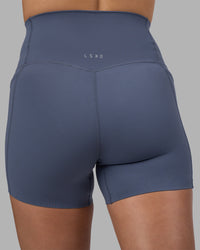 Woman wearing Elixir Ultra High-Rise 4" Short Pockets - Night Shadow | Model:Phoebe | Size:S