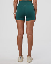 Woman wearing Elixir Ultra High-Rise 4" Short Pockets - Transformative Teal | Model:Myrte | Size:S