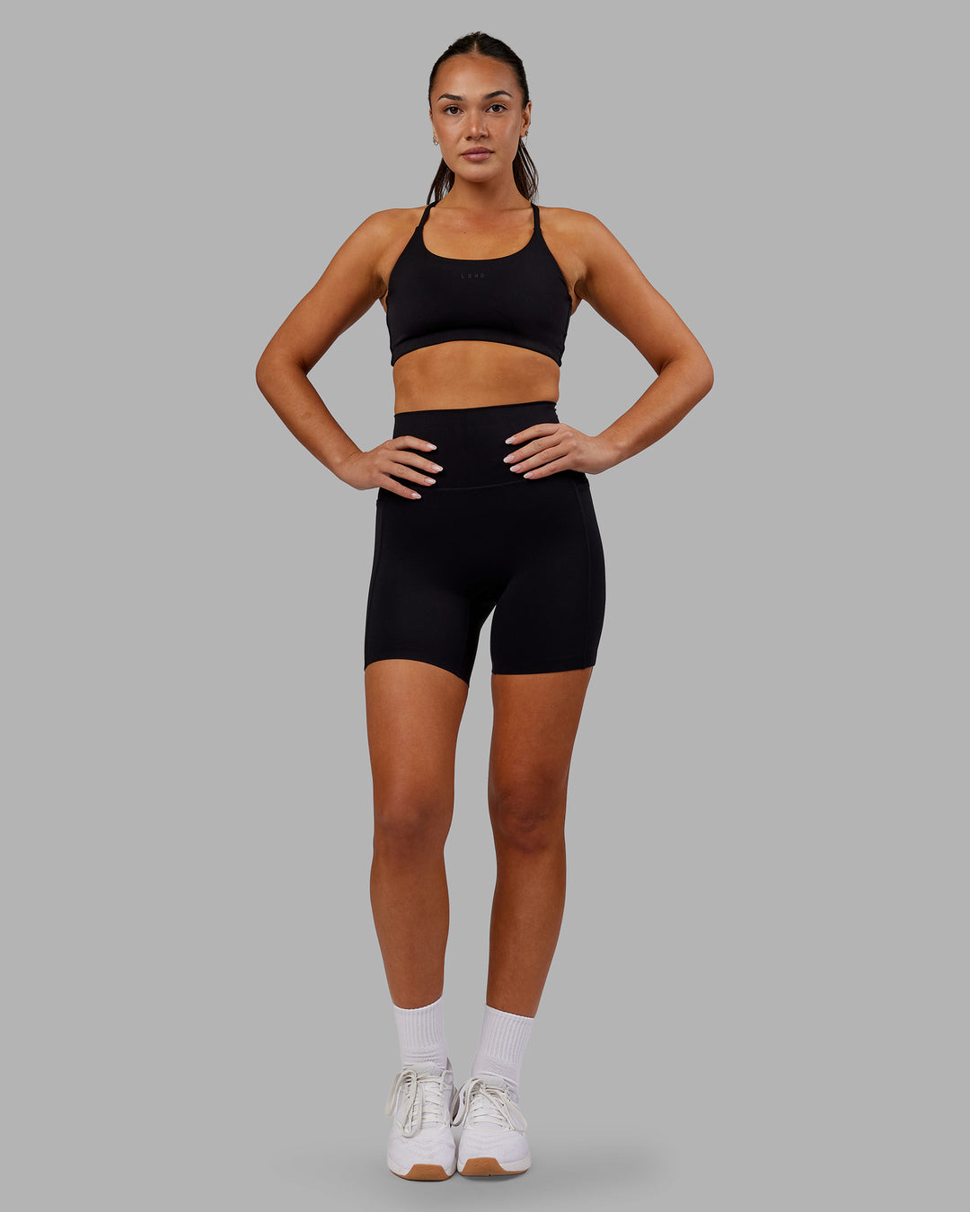 Woman wearing Elixir Ultra High-Rise 6&quot; Short Pockets - Black | Model:Kirstyn | Size:S