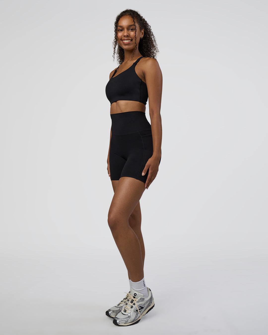 Woman wearing Elixir Ultra High-Rise 6" Short Pockets - Black | Model:Jordan | Size:S