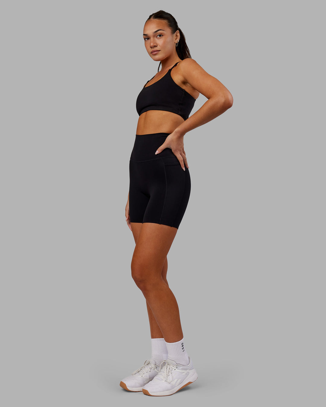Woman wearing Elixir Ultra High-Rise 6&quot; Short Pockets - Black | Model:Kirstyn | Size:S