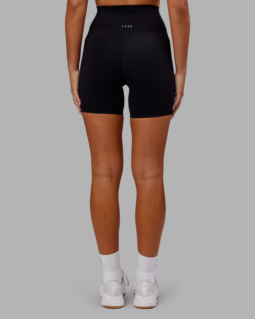 Woman wearing Elixir Ultra High-Rise 6&quot; Short Pockets - Black | Model:Kirstyn | Size:S