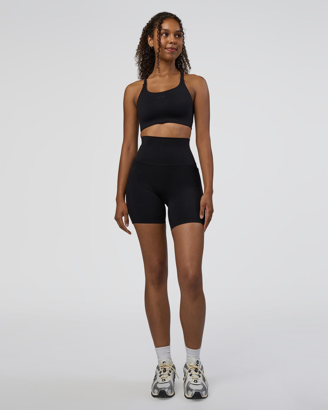 Woman wearing Elixir Ultra High-Rise 6" Short Pockets - Black | Model:Jordan | Size:S