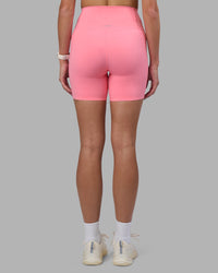 Woman wearing Elixir Ultra High-Rise 6" Short Pockets - Candy Pink | Model:Phoebe | Size:S