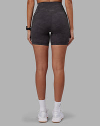 Woman wearing Elixir Ultra High-Rise 6" Short Pockets - Dark Storm Wash | Model:Rhiley | Size:S