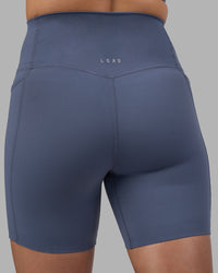 Woman wearing Elixir Ultra High-Rise 6" Short Pockets - Night Shadow | Model:Phoebe | Size:S
