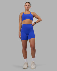 Woman wearing Elixir Ultra High-Rise 6" Short Pockets - Power Cobalt | Model:Keisha | Size:S